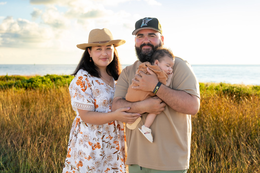 Nura with her husband and son by the water in Key West